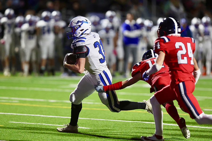 Preston football Conner Iverson pulls away from a tackler on his way to the end zone