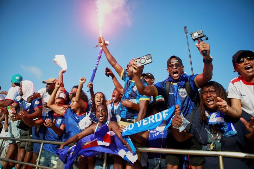 Fans celebrate in the stands after Cape Verde defeated Eswatini in a World Cup qualifying soccer match at Estádio Nacional in Praia, Cape Verde, Monday, Oct. 13, 2025, to clinch their qualification for the 2026 World Cup. (AP Photo/Cristiano Barbosa)