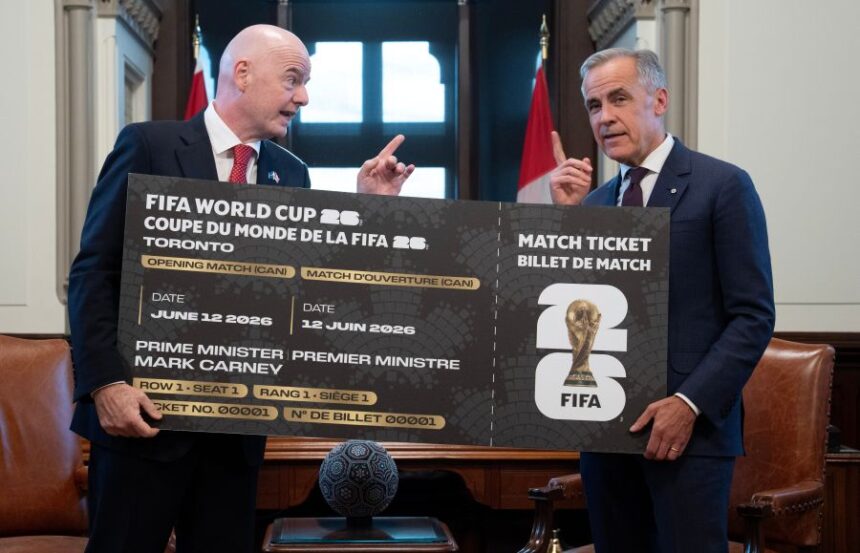 Canada Prime Minister Mark Carney, right, is presented with a novelty World Cup ticket by FIFA President Gianni Infantino on Parliament Hill in Ottawa, Ontario, Friday, Oct. 10, 2025. (Adrian Wyld/The Canadian Press via AP)