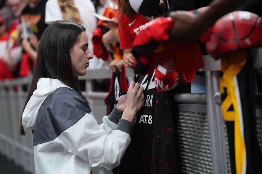 Indiana Fever's Caitlin Clark signs autographs before Game 3 of a WNBA basketball playoff semifinals series against the Las Vegas Aces, Friday, Sept. 26, 2025, in Indianapolis. (AP Photo/Darron Cummings)