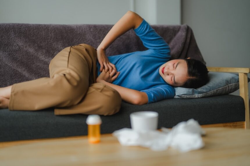 woman experiencing stomach pain resting on sofa n 2025 09 28 07 08 01 utc