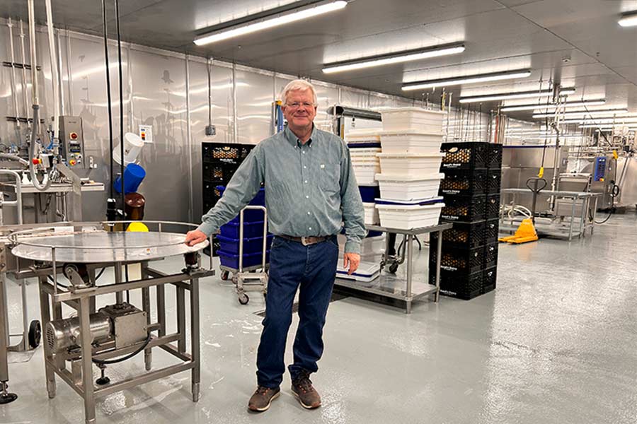 Alan Reed poses for a photo inside his new production building. | Rett Nelson, EastIdahoNews.com
