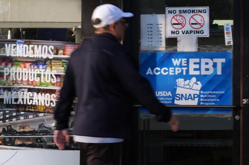 A customer walks into a bakery as a SNAP EBT information sign is displayed at the front door in Chicago, Sunday, Nov. 2, 2025. | Nam Y. Huh, Associated Press