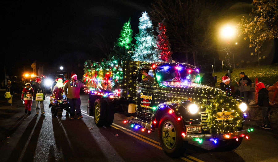 A brightly decorated vintage truck, a crowd favorite each year, rolls down the route during the 2025 Christmas Night Lights Parade. 