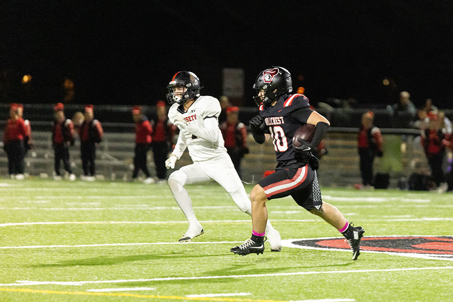Hillcrest football Maddox Ellingford races Shelley football Aiden Carlson to the edge. via Amy Ward