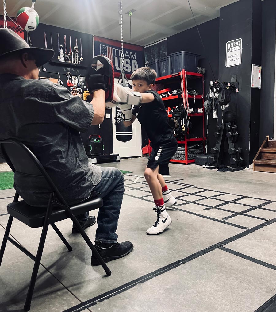 Nars Martinez, who had more than 200 matches during his own career and became a coach known and respected throughout the boxing world, works mitts with E.J. Chavez during a workout earlier this year. | | Courtesy Corey Taule