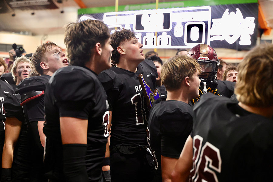 Rigby sings their alma mater with cheerleaders and fans