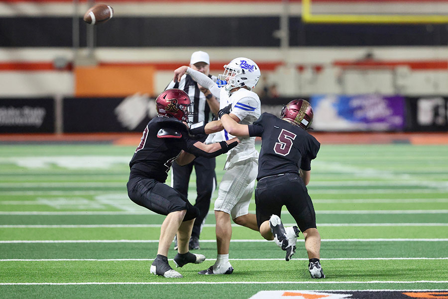 Rigby Ethan Hickman and DJ Bouderero (5) force an intentional grounding penalty on turnover on downs late in the Trojans' win