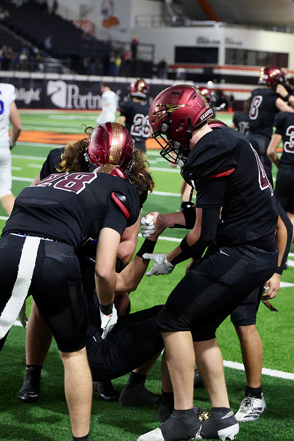 Rigby teammates help Flowers up after final play of game