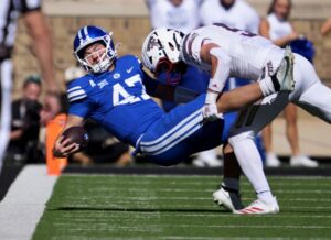 BYU quarterback Bear Bachmeier is driven to the ground by Texas Tech safety Cole Wisniewski during Saturday’s game in Lubbuck, Texas. | Scott G. Winterton, Deseret News.