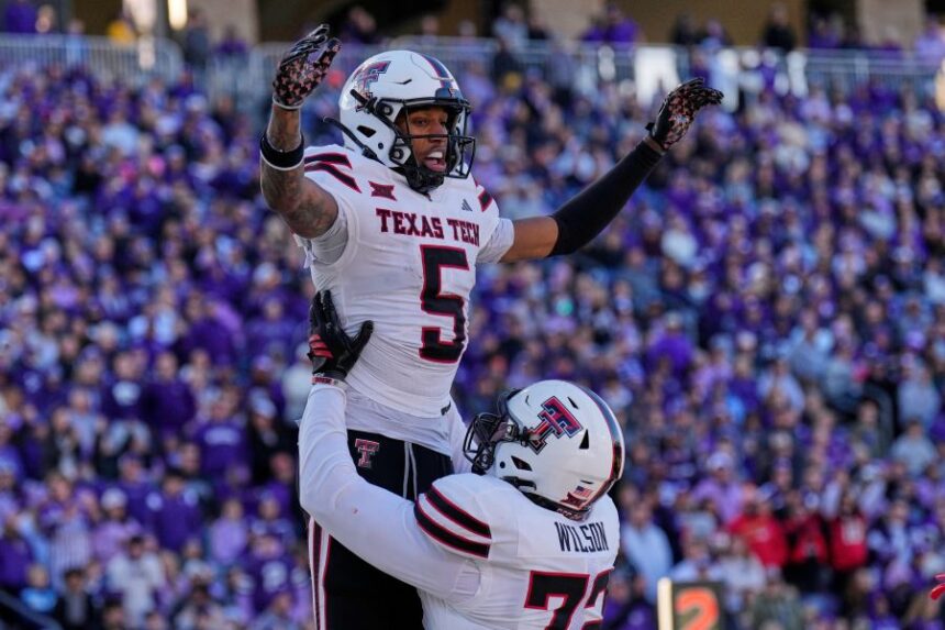 Texas Tech wide receiver Caleb Douglas (5) celebrates with offensive lineman Sheridan Wilson after scoring a touchdown during the second half of an NCAA college football game against Kansas State, Saturday, Nov. 1, 2025, in Manhattan, Kan. (AP Photo/Charlie Riedel)