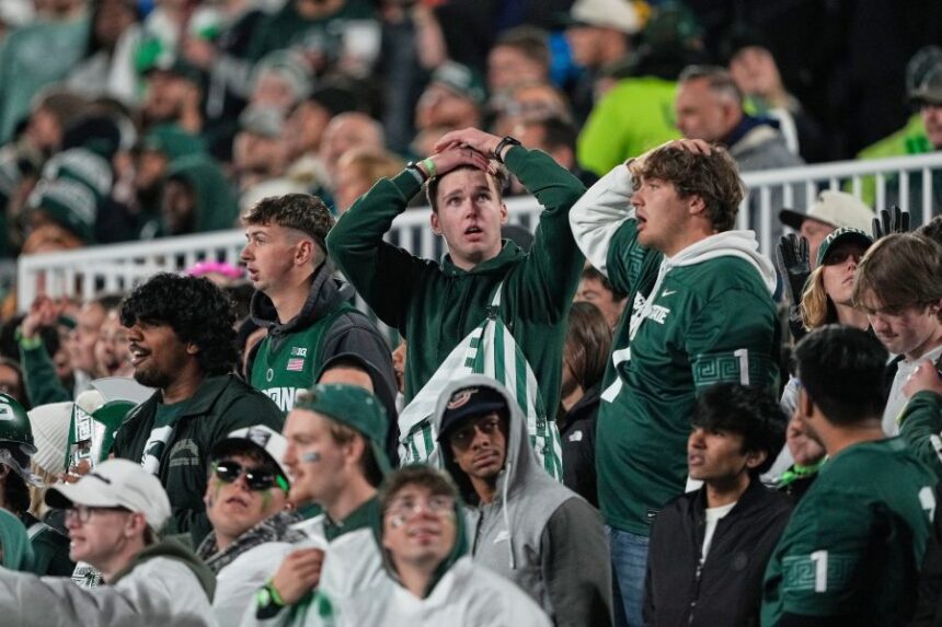 Michigan State fans react during the first half of an NCAA college football game against Michigan Saturday, Oct. 25, 2025, in East Lansing, Mich. (AP Photo/Ryan Sun)