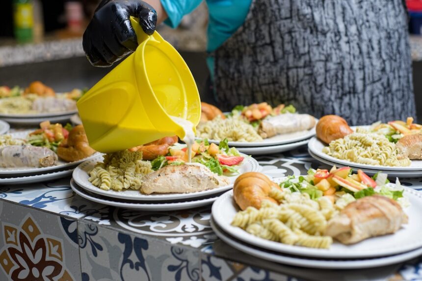 hand serving food on a plate catering service dur 2025 03 11 03 28 42 utc