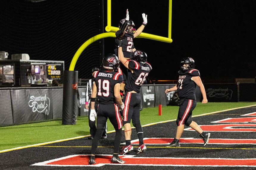 Hillcrest Damien Simmons hoists Elam Miner in the air after the sophomore running back scores a playoff touchdown