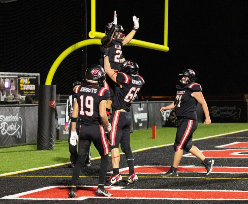 Hillcrest senior Damien Simmons hoists sophomore Elam Miner in the air after the running back scores a playoff touchdown in the Knights’ 40-15 victory over the Shelley Russets. | Photo courtesy Amy Ward