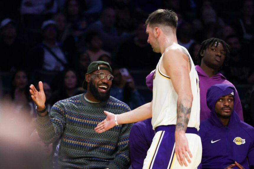 Los Angeles Lakers forward LeBron James, left, and guard Luka Doncic, center, celebrate as forward Jarred Vanderbilt, right, looks on during the second half of an NBA basketball game against the Miami Heat, Sunday, Nov. 2, 2025, in Los Angeles. (AP Photo/Jessie Alcheh)