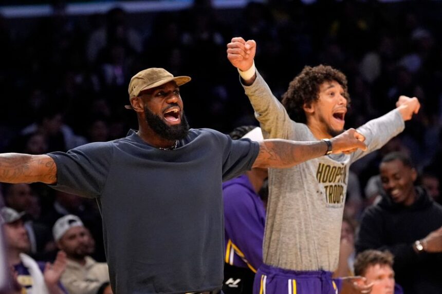 Los Angeles Lakers' LeBron James, left, and Jaxson Hayes gesture during the second half of an NBA basketball game against the San Antonio Spurs, Wednesday, Nov. 5, 2025, in Los Angeles. (AP Photo/Mark J. Terrill)