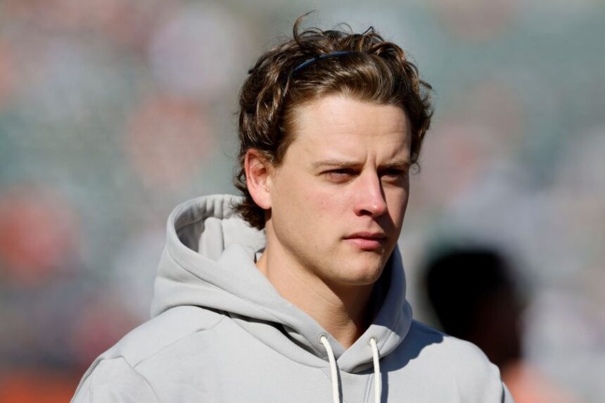 Injured Cincinnati Bengals quarterback Joe Burrow walks on the field before an NFL football game against the New England Patriots, Sunday, Nov. 23, 2025, in Cincinnati. (AP Photo/Jay LaPrete)