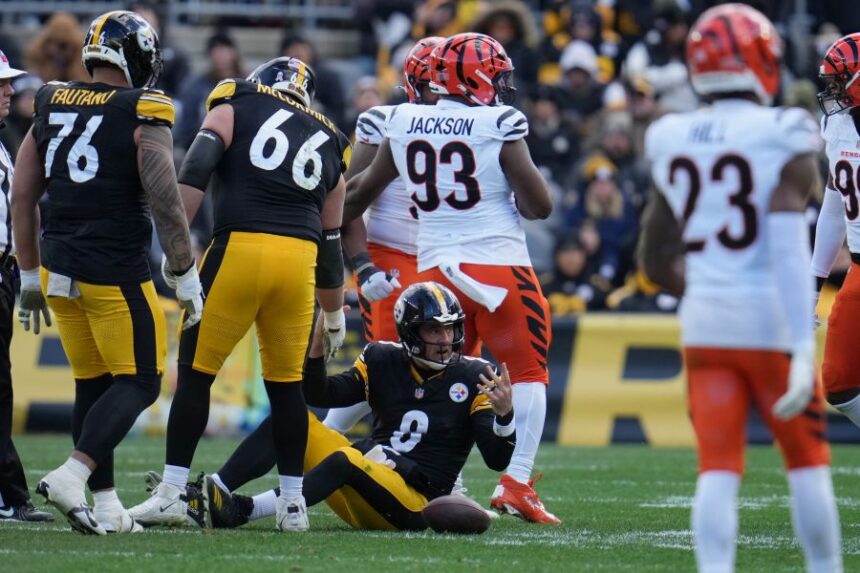 Pittsburgh Steelers quarterback Aaron Rodgers (8) reacts after he was sacked against the Cincinnati Bengals during the first half of an NFL football game Sunday, Nov. 16, 2025, in Pittsburgh. (AP Photo/Gene J. Puskar)