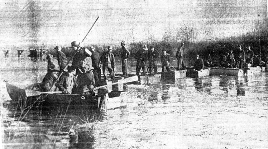 John L. Jones disappeared on Nov. 13, 1940. Pictured above are some 30 men using 11 boats in pontoon fashion as they drag the river bottom using grappling irons and poles. Caption dated Nov. 21, 1940.