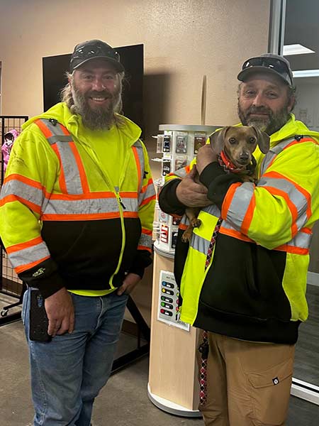 Two men with Idaho Transportation Department holding Tessa after finding her along I-15 near Spencer. | Courtesy Michelle Ziel-Dingman