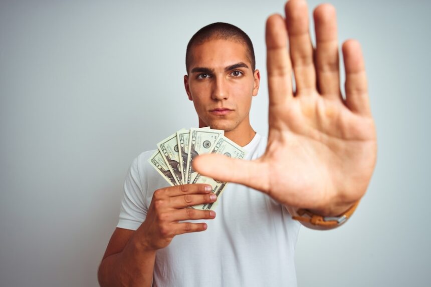 young handsome man holding dollars over white isol 2025 10 13 08 25 20 utc