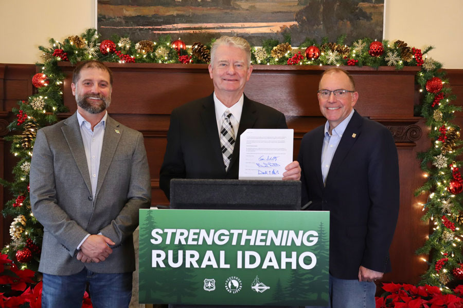 Gov. Brad Little holds the new Shared Stewardship agreement signed Friday with Idaho Department of Lands Director Dustin Miller, left, and Chief of the U.S. Forest Service Tom Schultz, right. (courtesy of Gov. Brad Little’s office)