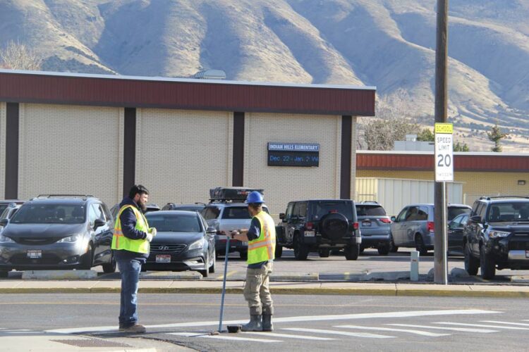 Workers on site in front of Indian Hills Elementary School.