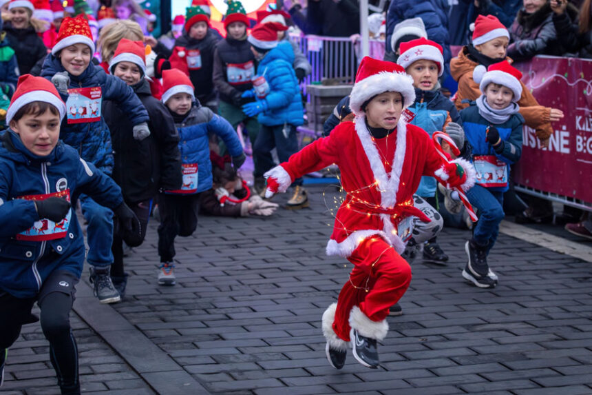 Decked in a Santa outfit and holiday lights, a child bolts from the starting line of the annual Christmas run in Vilnius, Lithuania, Saturday, Dec. 6, 2025. | Mindaugas Kulbis, Associated Press