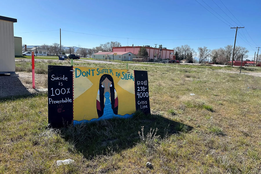A sign outside the Fort Hall Reservation’s recreation center advertises a suicide crisis number. Diabetes and high suicide rates are among the most pernicious tribal health challenges. | Sarah Jane Tribble, KFF Health News