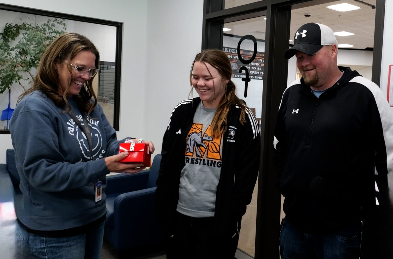 Husband, wife and daughter are called to the school office for surprise from a Secret Santa
