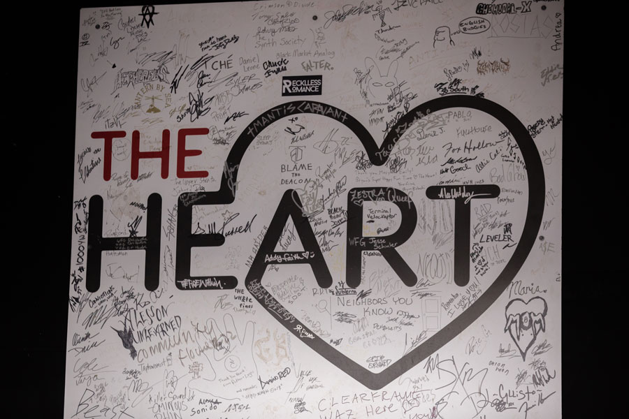 A sign shows the signatures of artists who have played at The Heart Events. | Cody Roberts
