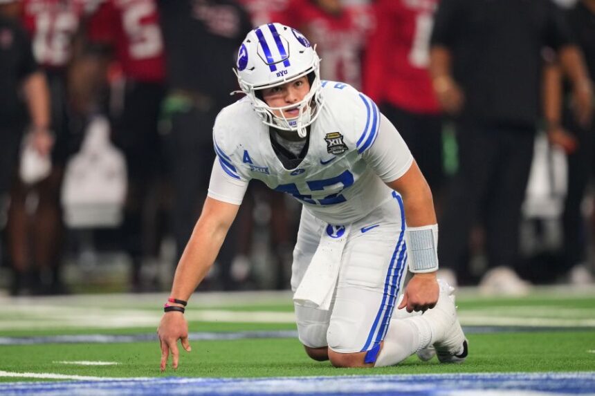BYU quarterback Bear Bachmeier gets up off the field after being knocked down while throwing a pass in the first half of a Big 12 Conference championship NCAA college football game against Texas Tech Saturday, Dec. 6, 2025, in Arlington, Texas. (AP Photo/Julio Cortez)