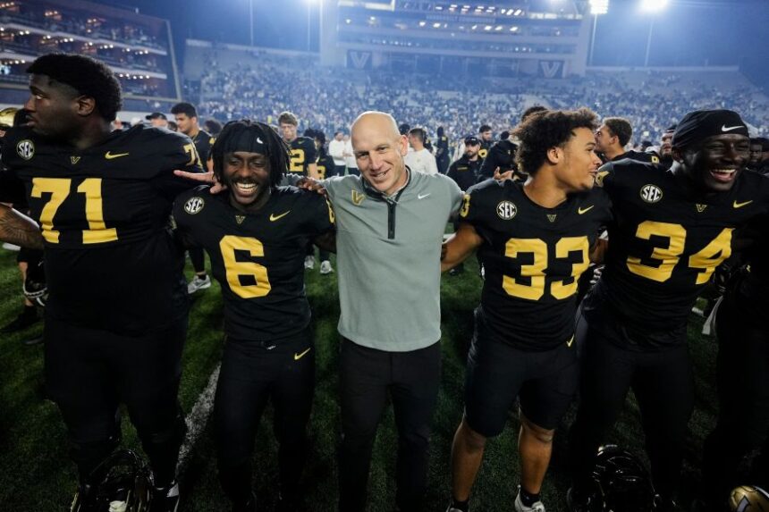 Vanderbilt head coach Clark Lea, center, celebrates the team's win with players after an NCAA college football game against Kentucky, Saturday, Nov. 22, 2025, in Nashville, Tenn. (AP Photo/George Walker IV)