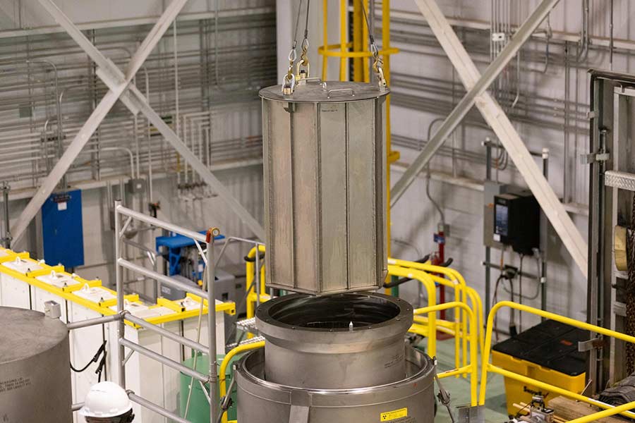A GEO basket, the inner container of the shipping package, is removed from the containment vessel's transport cask. | Courtesy INL