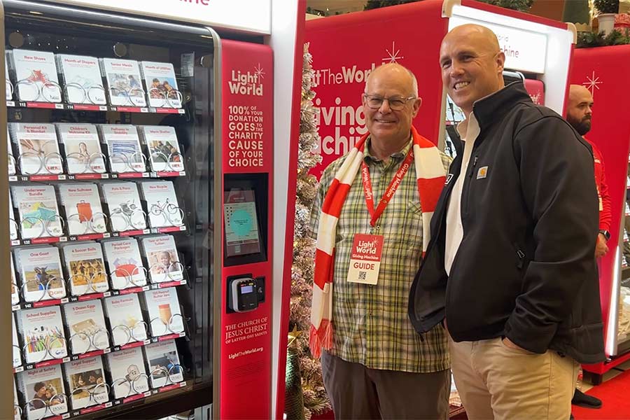 Brad Hall Companies CEO Logan Hall, right, with a volunteer at the Giving Machines in Idaho Falls | Rett Nelson, EastIdahoNews.com