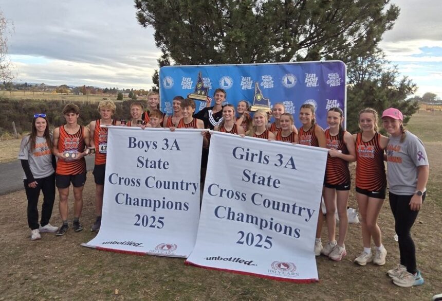 The Malad boys and girls cross country teams celebrate 3A state titles. | Courtesy photo.