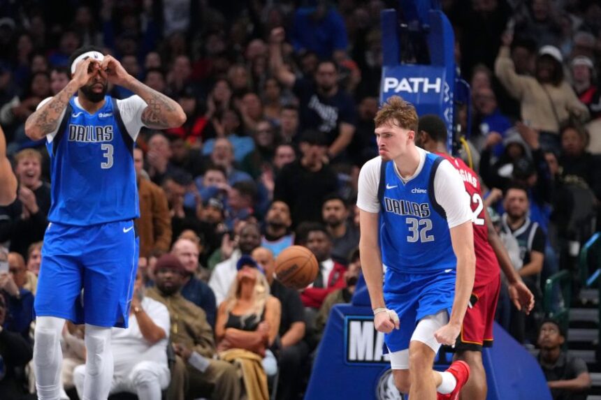 Dallas Mavericks guard Ryan Nembhard (9), forward Cooper Flagg (32) and forward Anthony Davis (3) react after a basket against the Miami Heat during the second half of an NBA basketball game Wednesday, Dec. 3, 2025, in Dallas. (AP Photo/Julio Cortez)