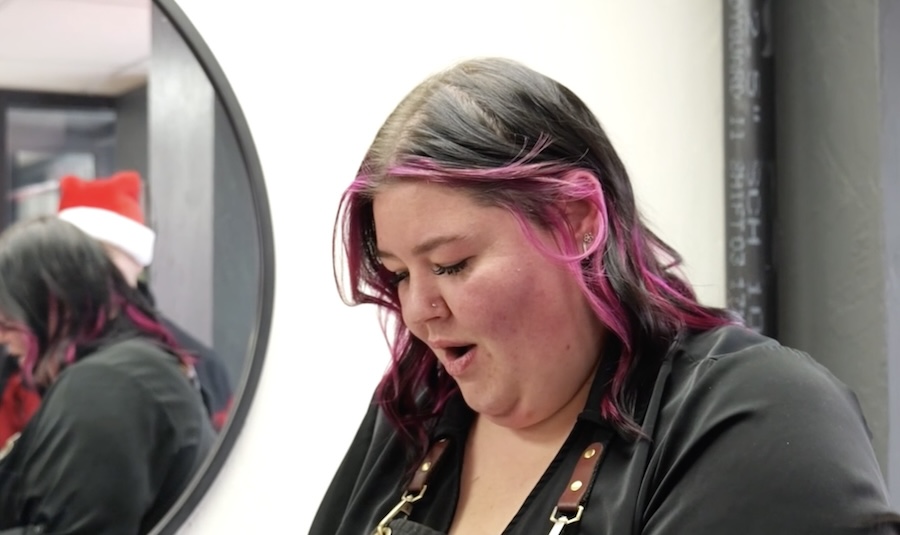 Hairdresser is surprised with a gift from Secret Santa in the middle of an appointment