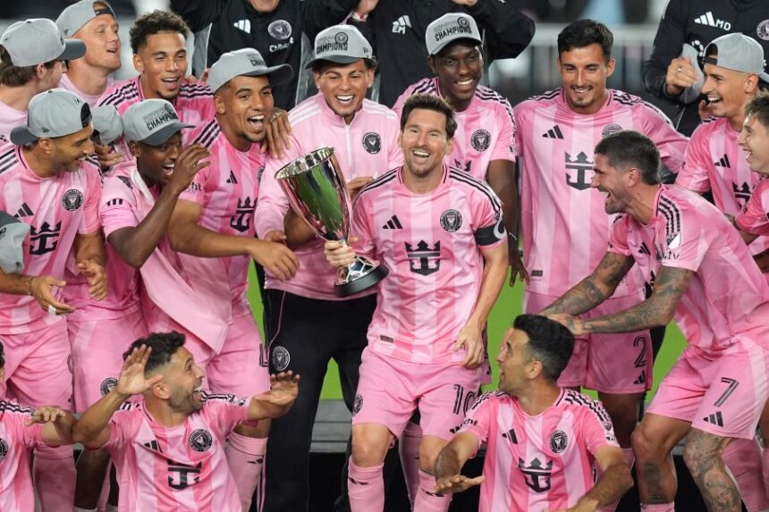 Inter Miami forward Lionel Messi (10) holds the trophy as Inter Miami players celebrate winning an MLS Eastern Conference final soccer match against New York City FC, Saturday, Nov. 29, 2025, in Fort Lauderdale, Fla. (AP Photo/Rebecca Blackwell)