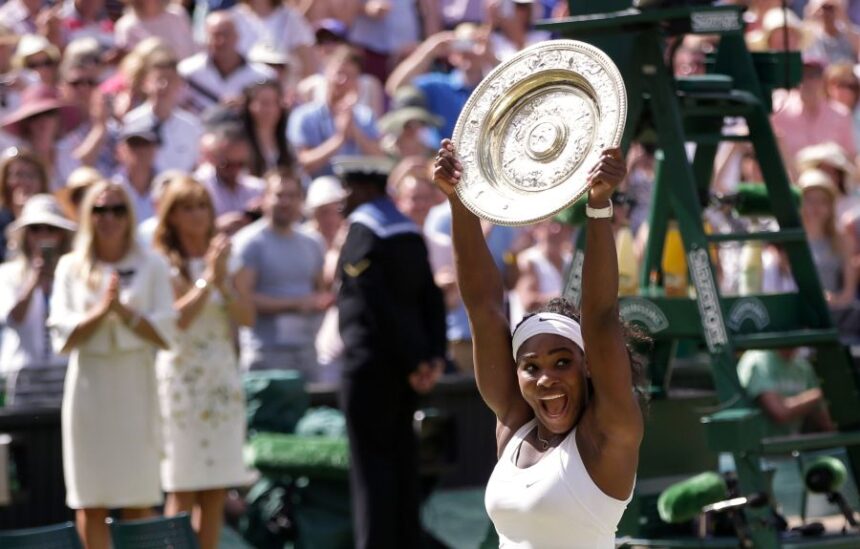 FILE - Serena Williams, of the United States, reacts as she holds up the trophy after winning the women's singles final against Garbine Muguruza of Spain, at the All England Lawn Tennis Championships in Wimbledon, London, Saturday July 11, 2015. (AP Photo/Pavel Golovkin, File)
