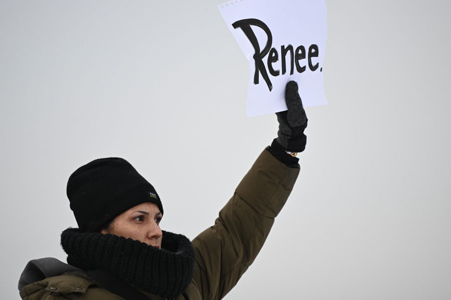 A protesters holds up a sign reading "Renee", the woman shot and killed by a U.S. Immigration and Customs Enforcement officer in Minneapolis on Wednesday, outside the Bishop Henry Whipple Federal Building, Thursday, Jan. 8, 2026, in Minneapolis, Minn. | Tom Baker, Associated Press