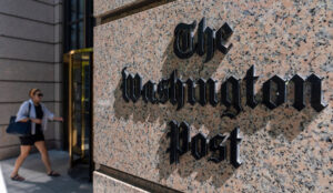 FILE - A person walks into the One Franklin Square Building, home of The Washington Post newspaper, June 21, 2024, in Washington. (AP Photo/Alex Brandon, File)