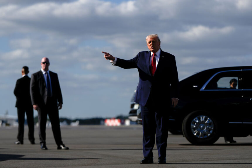 President Donald Trump points after arriving at Palm Beach International Airport on Air Force One, Friday, Jan. 16, 2026, in West Palm Beach, Fla. (AP Photo/Julia Demaree Nikhinson)
