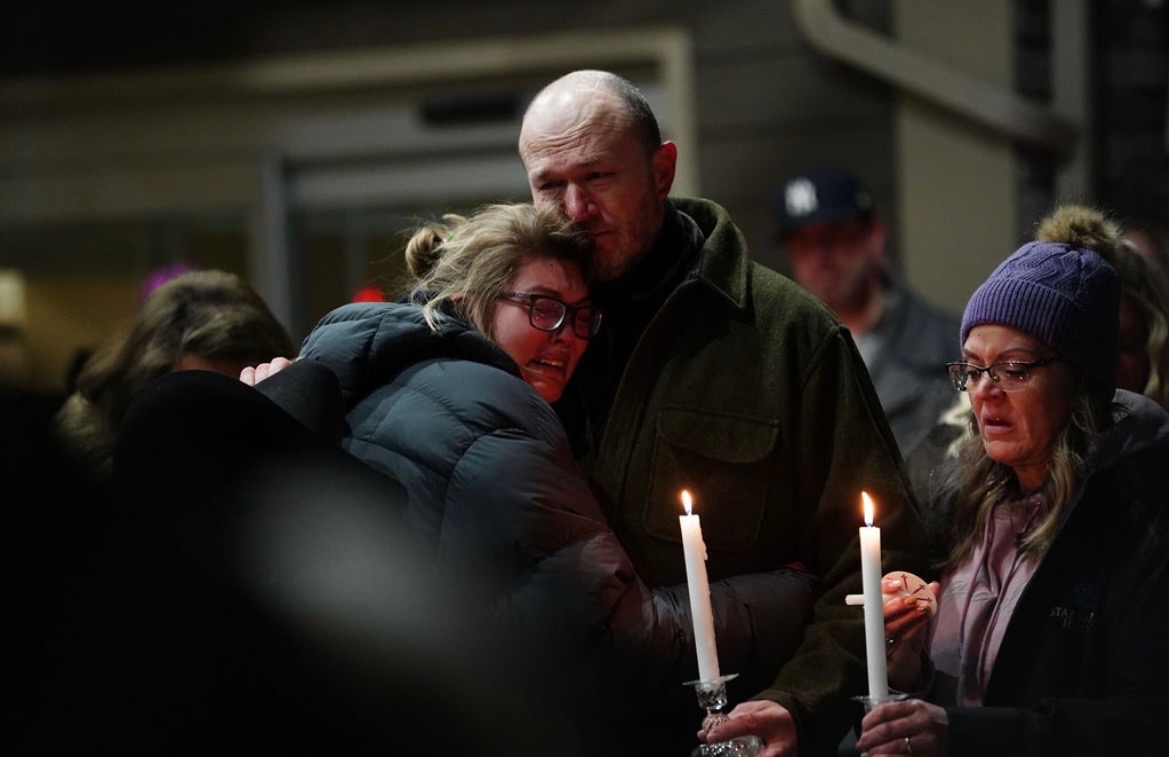 Cassie's sister Jess, her father Jared, and her mother Cynthia at a vigil after her death. | Courtesy of Cynthia Clinger