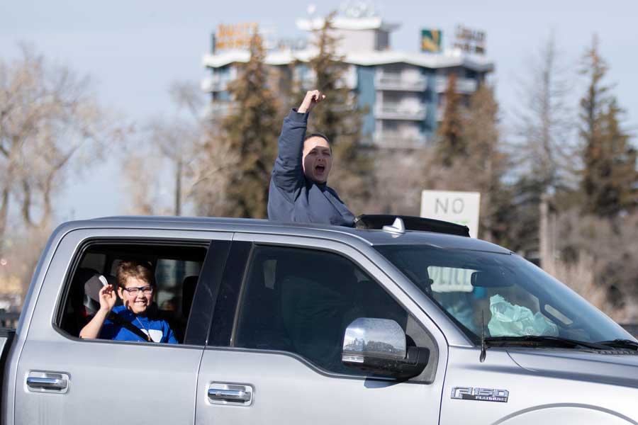 A passerby raises their fist in the air while in a truck driving by a protest in Idaho Falls on Saturday, Jan. 31, 2026.