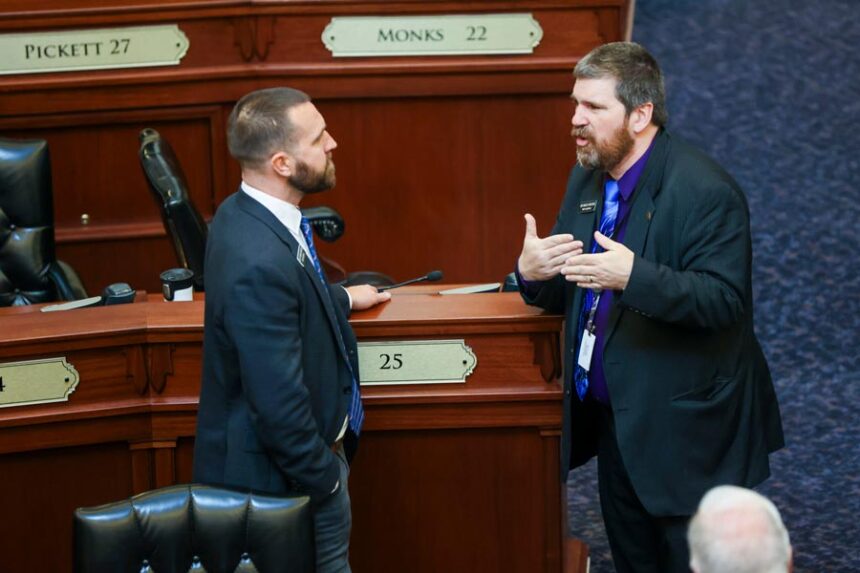 Rep. Jordan Redman, R-Coeur d’Alene, (left) chats with Rep. Marco Erickson, R-Idaho Falls, on Idaho House of Representatives floor before it officially gavels into session on Jan. 14, 2026, at the State Capitol Building in Boise. (Photo by Pat Sutphin for the Idaho Capital Sun)