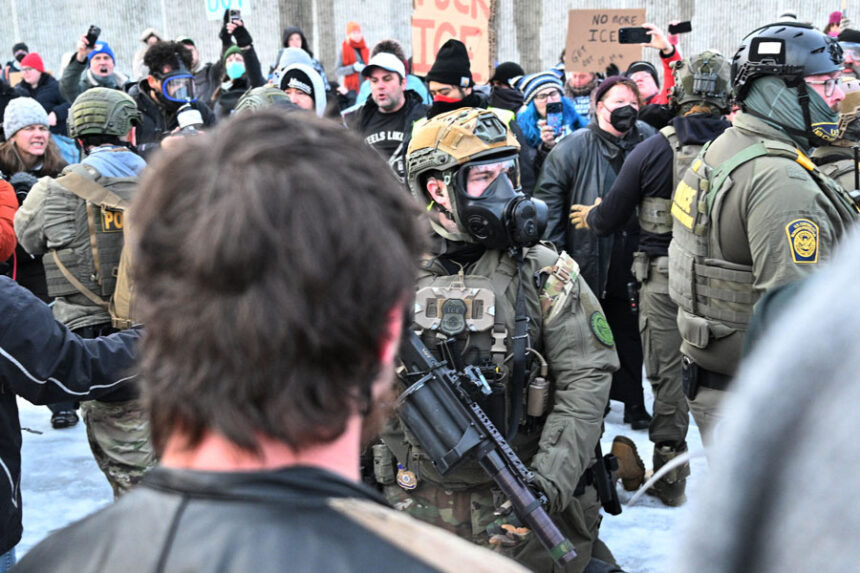 Federal agents confront protesters outside the Bishop Henry Whipple Federal Building, Thursday, Jan. 8, 2026, in Minneapolis, Minn. (AP Photo/Tom Baker)