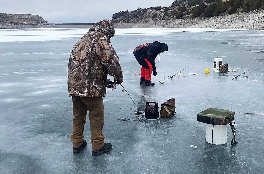 Two men fish on 3-inch-thick ice near the Juniper boat ramp on Ririe Reservoir, Wednesday, Jan. 28, 2026.