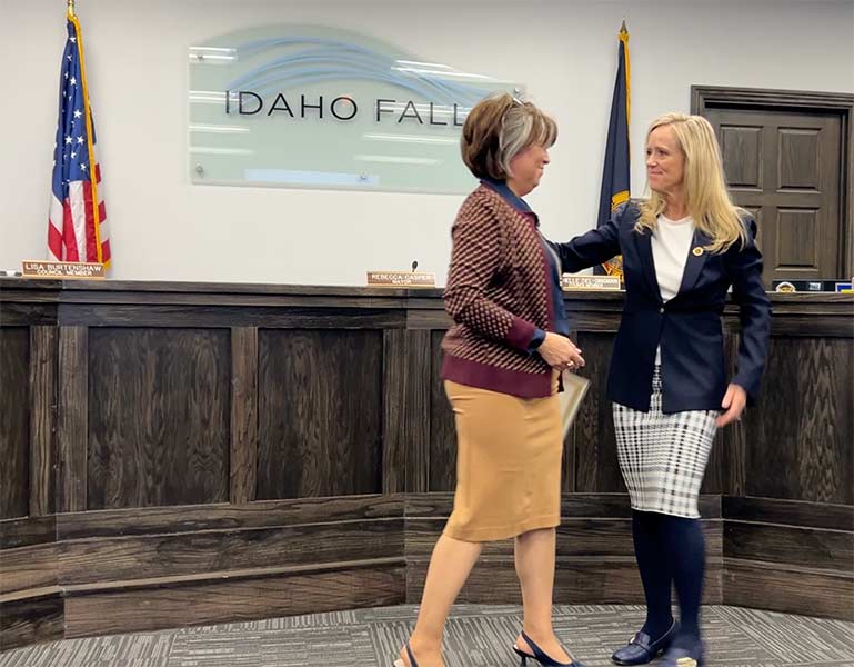 Outgoing Mayor Rebecca Casper, left, and incoming Mayor Lisa Burtenshaw sharing a moment together during Thursday night's swearing in ceremony. | Rett Nelson, EastIdahoNews.com